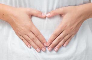 Heart shaped hands of woman on t-shert photo
