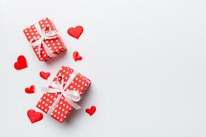 Valentine day composition red gift box with bow and heart. Christmas present. View from above. Space for text. Holday greeting card photo