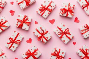 Valentine day composition Background red gift box with bow and heart. Christmas present. View from above. Holday greeting card photo