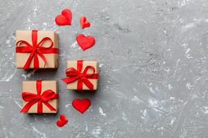 Valentine day composition red gift box with bow and heart. Christmas present. View from above. Space for text. Holday greeting card photo