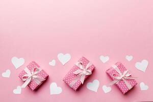 Valentine day composition red gift box with bow and heart. Christmas present. View from above. Space for text. Holday greeting card photo