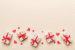 Valentine day composition red gift box with bow and heart. Christmas present. View from above. Space for text. Holday greeting card photo