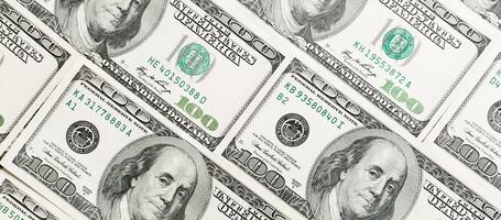 Close up of 100 dollar bills as a background. Amarican dollars pattern. Top view of business concept photo