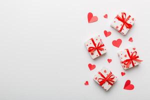 Valentine day composition red gift box with bow and heart. Christmas present. View from above. Space for text. Holday greeting card photo