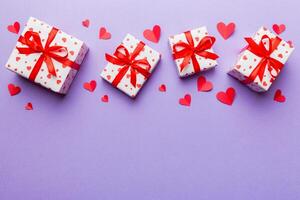 Valentine day composition red gift box with bow and heart. Christmas present. View from above. Space for text. Holday greeting card photo