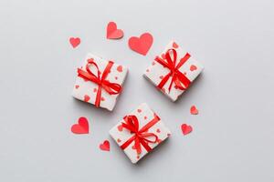 Valentine day composition Background red gift box with bow and heart. Christmas present. View from above. Holday greeting card photo