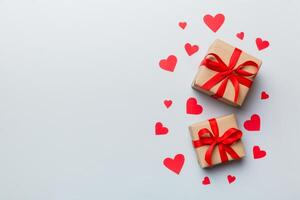 Valentine day composition red gift box with bow and heart. Christmas present. View from above. Space for text. Holday greeting card photo