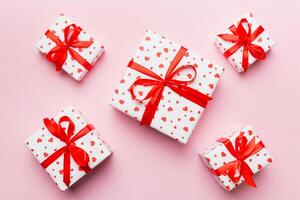 Valentine day composition Background red gift box with bow and heart. Christmas present. View from above. Holday greeting card photo