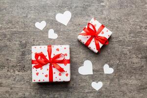 Valentine day composition Background red gift box with bow and heart. Christmas present. View from above. Holday greeting card photo