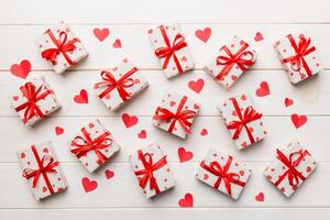 Valentine day composition Background red gift box with bow and heart. Christmas present. View from above. Holday greeting card photo