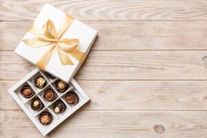 White box with chocolates candies and golden tape. top view with copy space photo