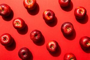 Many red apples on colored background, top view. Autumn pattern with fresh apple above view photo