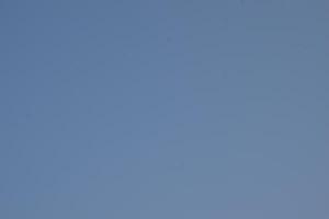 a clear blue sky with some clouds in it photo