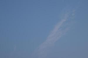 a clear blue sky with some clouds in it photo