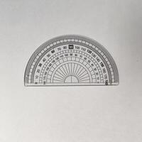 Close-up of a transparent protractor with a 0 to 180-degree scale, placed on a plain white background. This tool is commonly used for measuring angles photo