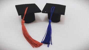 Miniature Graduation Cap with Red Tassel on a White Background photo