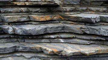 Closeup of layered rock formation with a rough texture and an uneven surface. photo