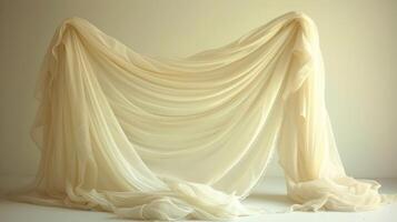 A white fabric drapes over a white background, creating a soft and elegant backdrop. photo