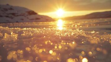 Close-up of sparkling ice crystals on a frozen lake at sunset with a sun-kissed mountain range in the background. photo