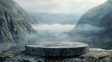 Stone platform on a mountain cliff overlooking a foggy valley. photo