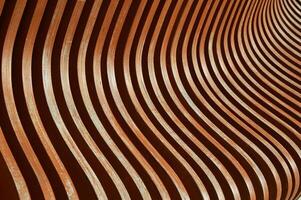 Brown wooden planks, fragment of a bench with curved geometry, vertical planks. Abstract background. photo