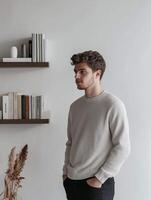 A Young Man Posed in a Minimalistic Indoor Setting, Surrounded by Thoughtful Decor and Elegance photo