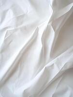 A beautifully wrinkled white fabric background ideal for textile and design projects photo