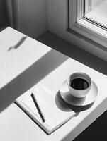 Photography with a serene workspace with a blank notebook, a cup of coffee, and greenery creating a tranquil atmosphere photo
