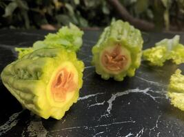 A close up of two green vegetables with a bite taken out of them photo
