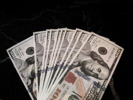 A pile of money on a black surface photo