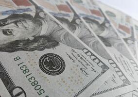 A close up of a stack of one hundred dollar bills photo
