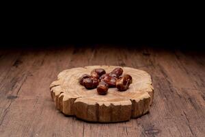 Many Date Palms are on bowls and cups of water and the Quran is on wooden tables, to wait for the time of Iftar, with the concept of ramadan Muslims around the world. photo