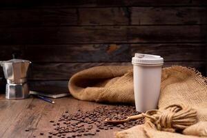 The picture of coffee beans stacked together on a wooden floor in a warm, light atmosphere, on a dark background, with copy space. photo