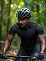 Indian Man Mountain Biking on a Trail Through the Lush Forest photo