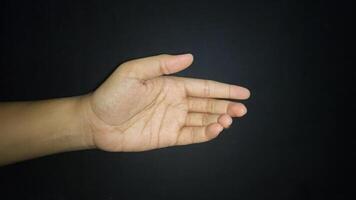 Hands show a gesture of giving help. Isolated on black background photo
