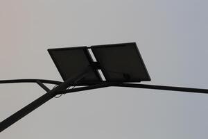 A solar panel is attached to a pole photo