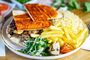 Close up of Middle Eastern Arab meal with fried potato, falafel, hummus, vegetables salad photo