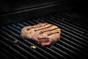 Juicy steak Meat Roasted BBQ Grill. Steak beef Grilled On Hot Barbecue Charcoal Flaming Grill. Grill Dish Closeup View. photo