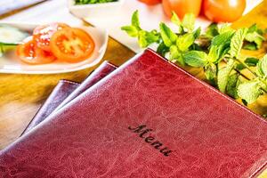 Menu restaurant fresh tomatoes with mint and basil on wooden table over bokeh background photo