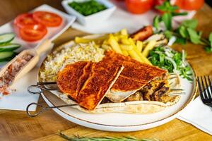 Close up of Middle Eastern Arab meal with fried potato, falafel, hummus, vegetables salad photo