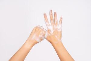 Woman using hand sanitizer to prevent spread of virus or bacteria isolated on white background photo