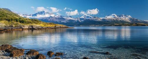 The serene Beagle Channel, with clear blue waters, glaciers, and the rugged mountains of Tierra del Fuego in the background photo