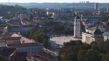 Aerial view of Vilnius, Lithuania, featuring the Vilnius Cathedral and bell tower amidst historic architecture and lush greenery. video