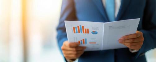 Person in suit analyzing data reports with graphs and charts. photo