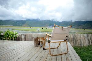 Empty table and chairs with beautiful lake and mountains view, landscape concept. photo