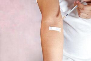hand holding injection and showing injection marks photo
