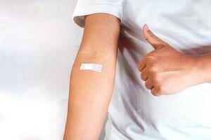 hand shows arm with injection marks and giving thumb up photo
