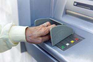 Person using an atm for secure banking transactions and money withdrawals photo