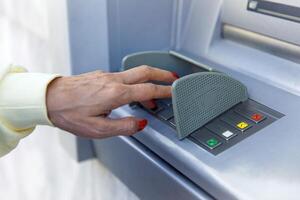 Hand using atm keypad for secure banking transaction photo