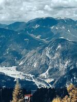 Majestic mountain views of the alps with cloudy sky and dense forests photo